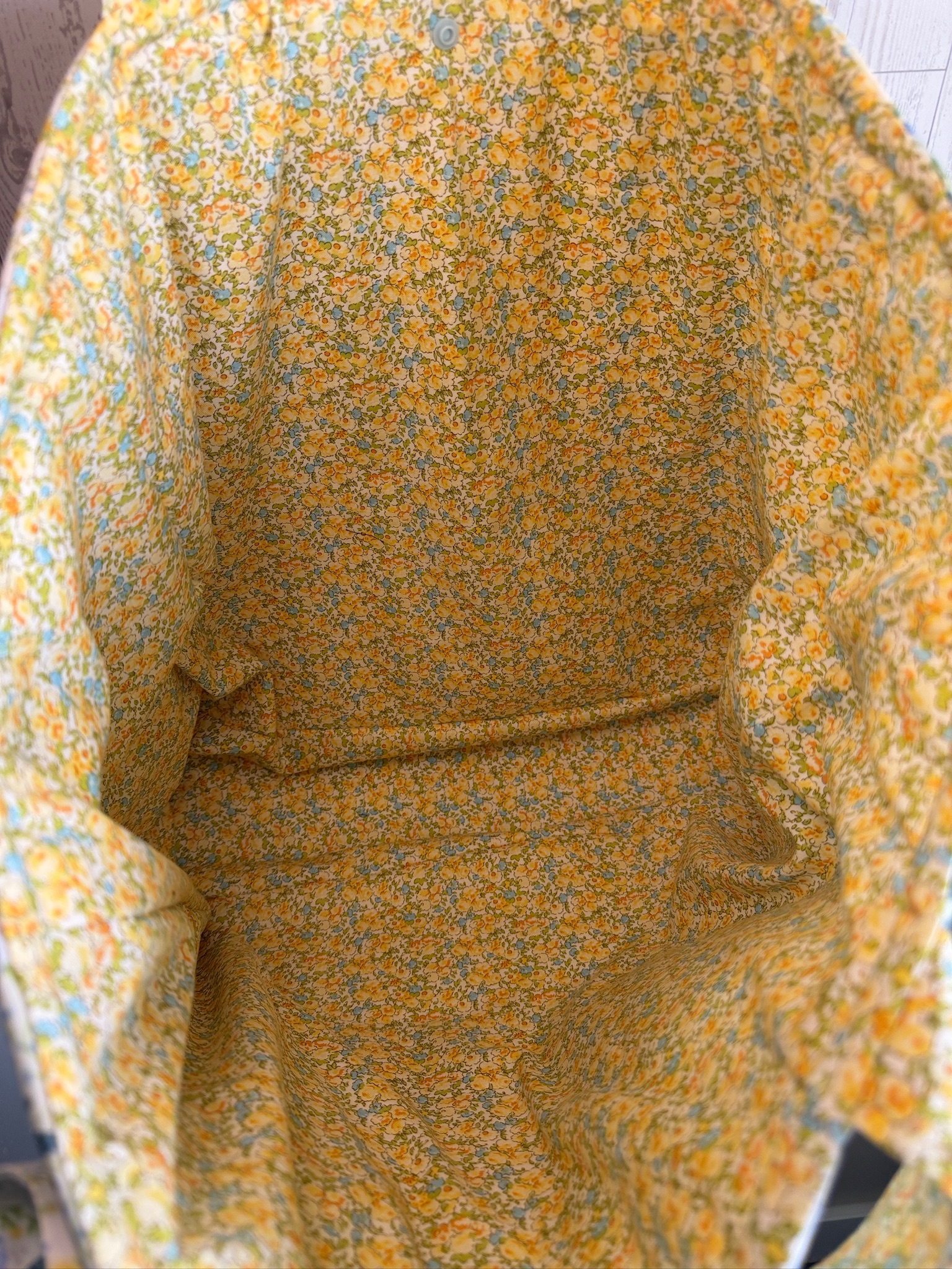 Interior of the patchwork market tote bag showing yellow floral lining