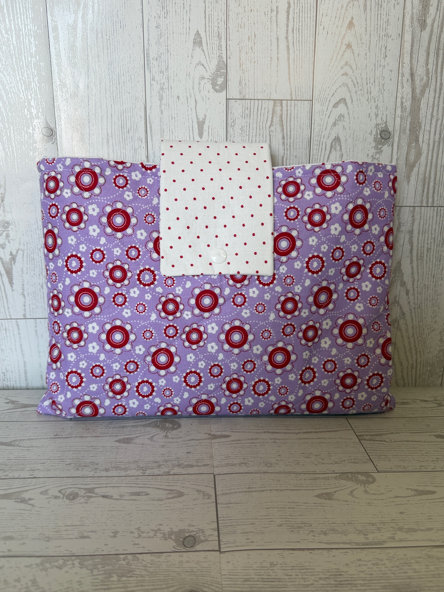 Lavender medallion book sleeve shown open with the red and white polka dot inner pocket