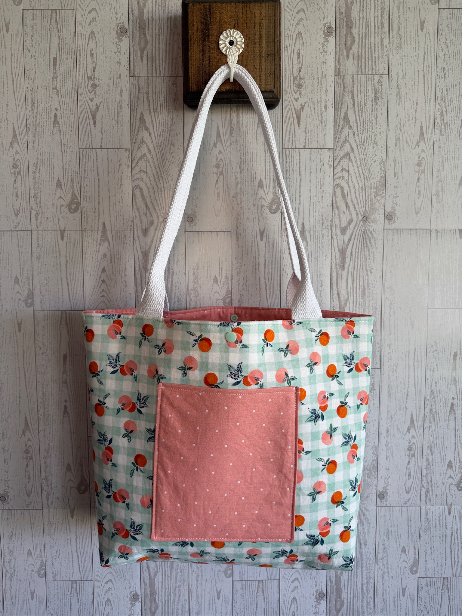 Handmade mint tote bag with orange clementine print and a coral front pocket