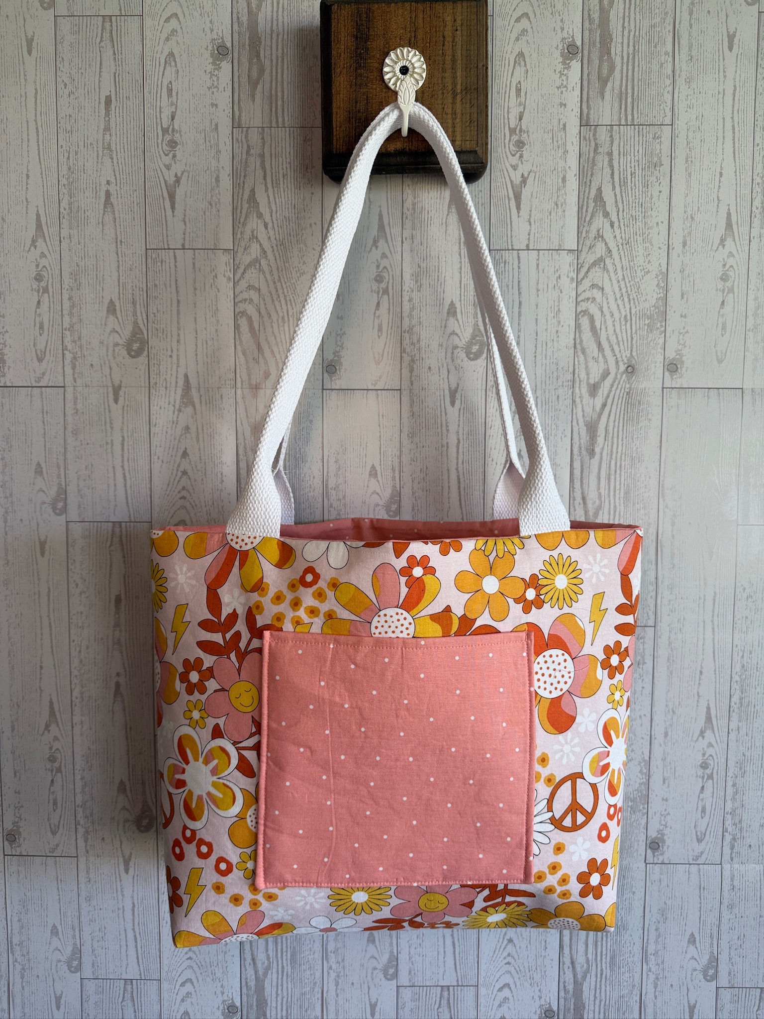 Handmade retro orange and gold floral tote bag with a blush pink front pocket