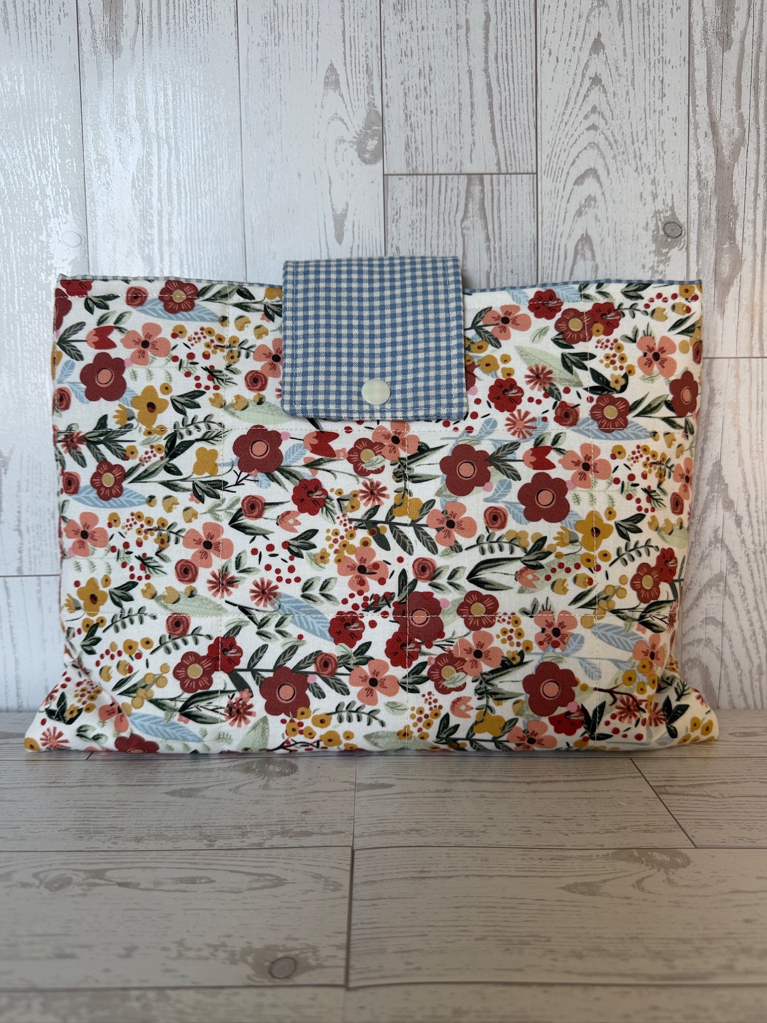 Handmade wildflower print quilted book sleeve with blue gingham snap flap closure