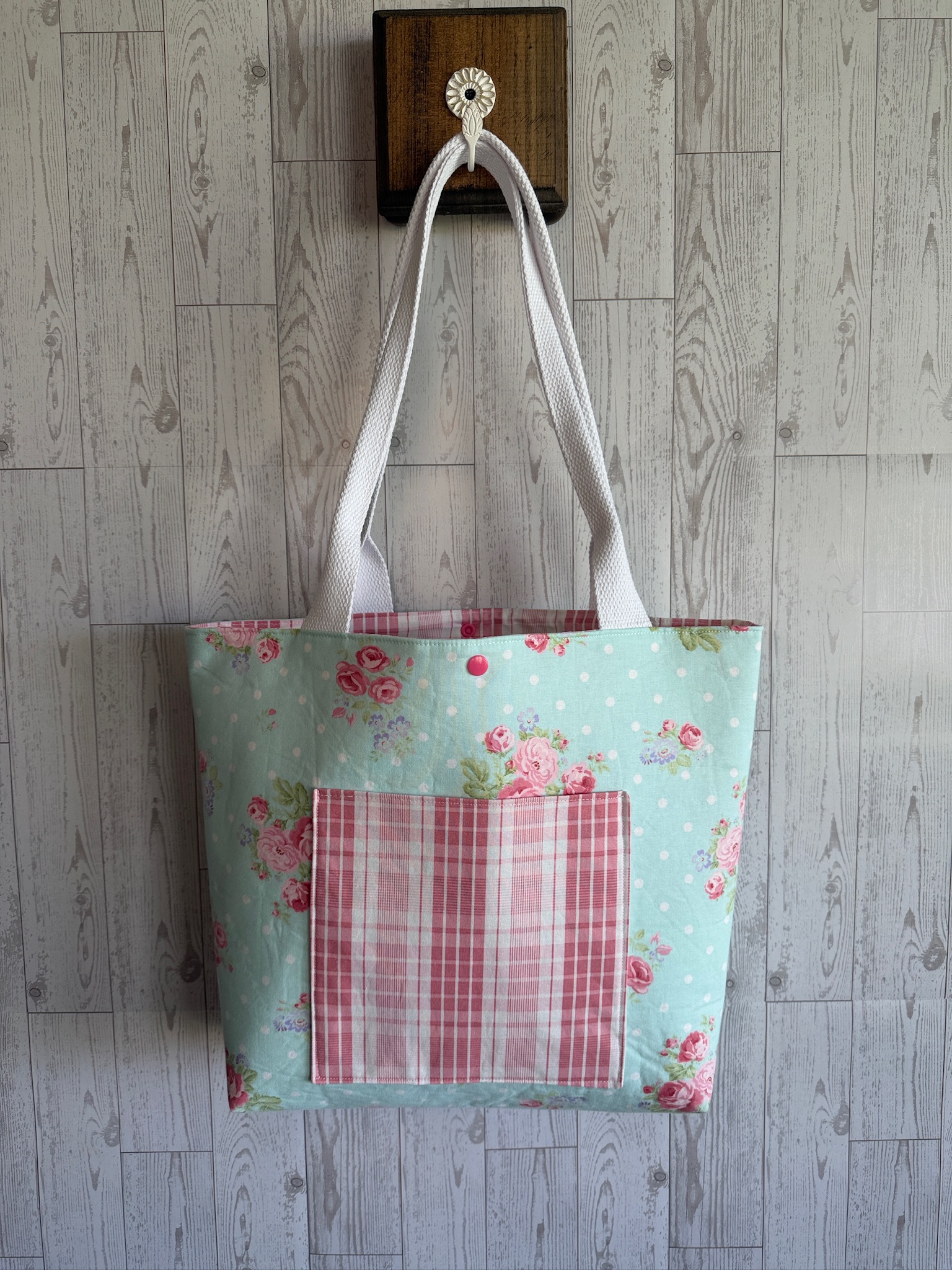 Handmade mint green rosebud print tote bag with a pink striped front pocket