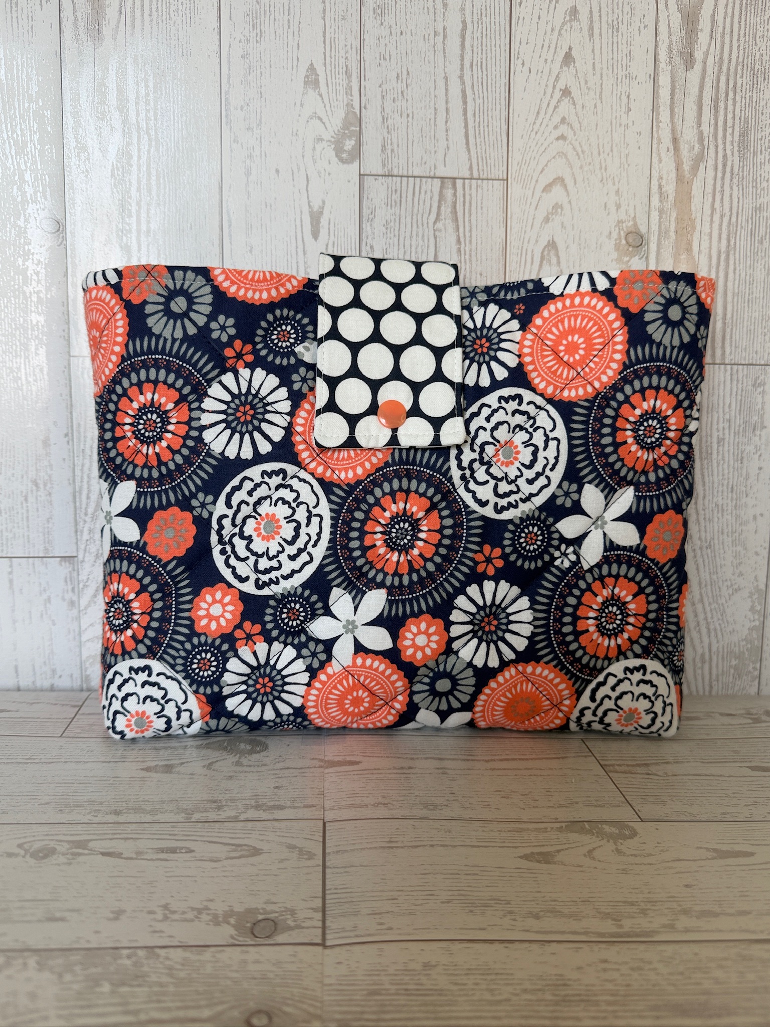 Handmade navy coral and cream floral quilted book sleeve laid flat