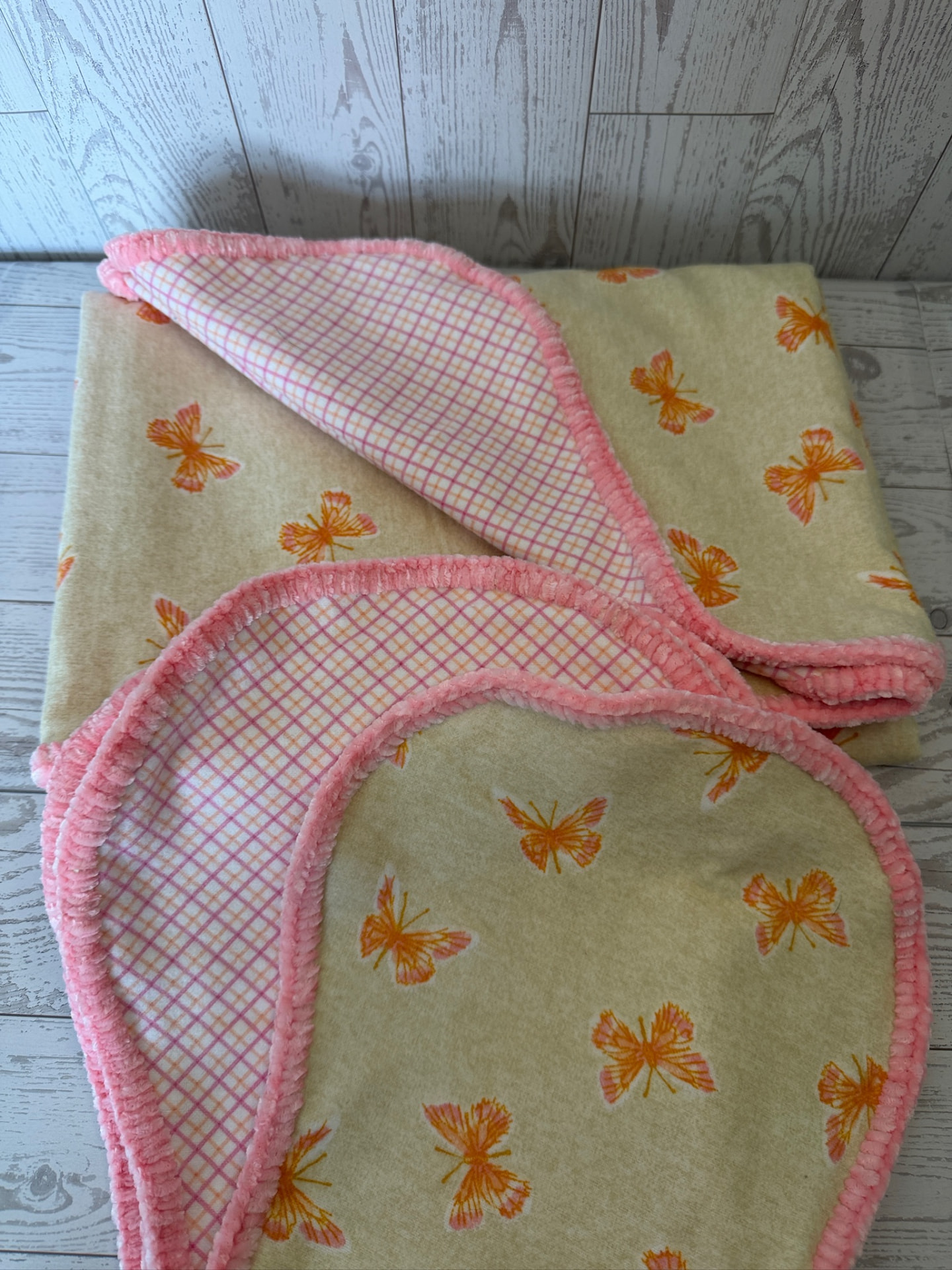 Handmade yellow butterfly flannel baby blanket with pink plaid reverse and coral chenille trim