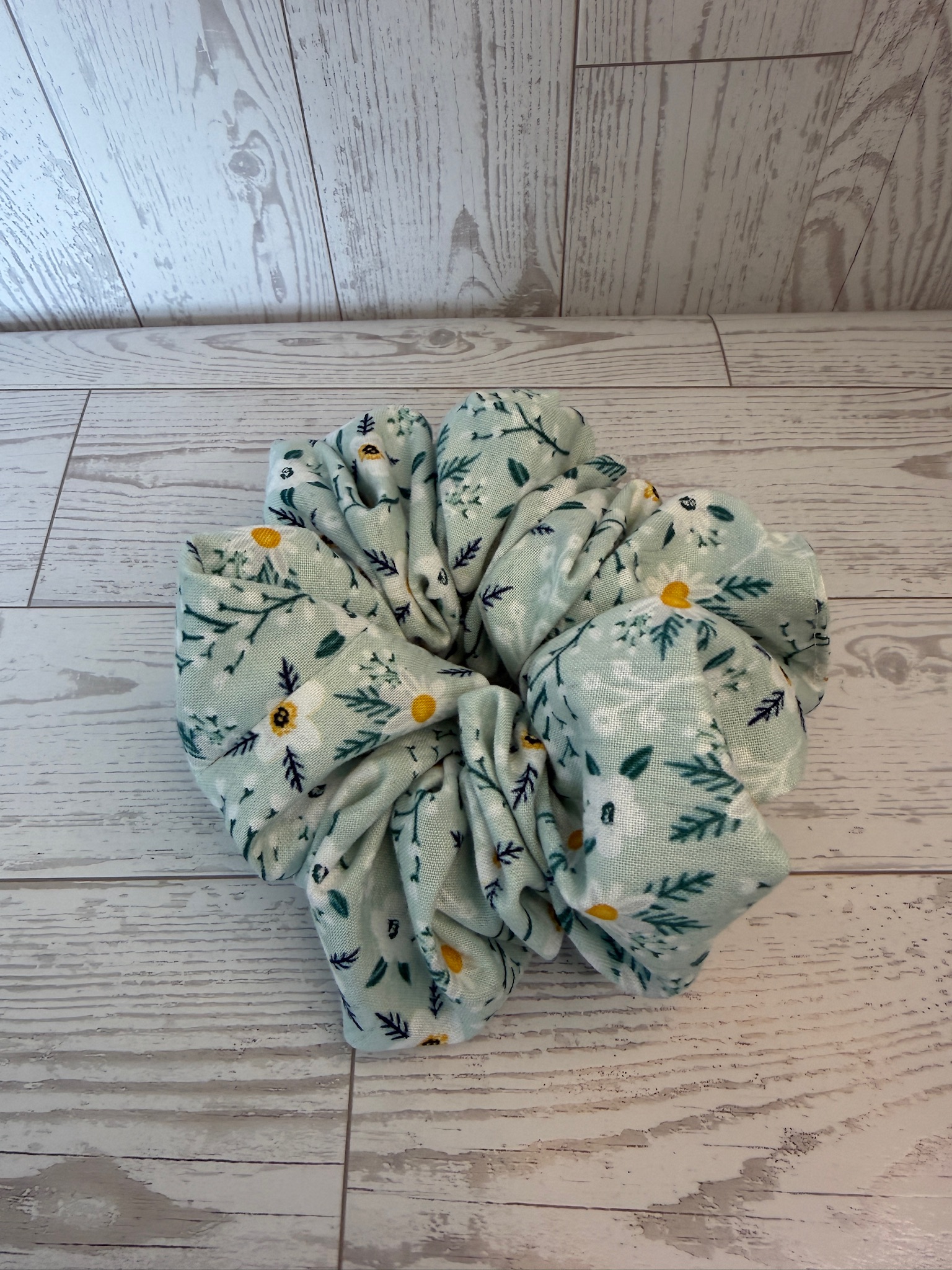 Single oversized handmade scrunchie in mint cotton with white daisy and greenery print